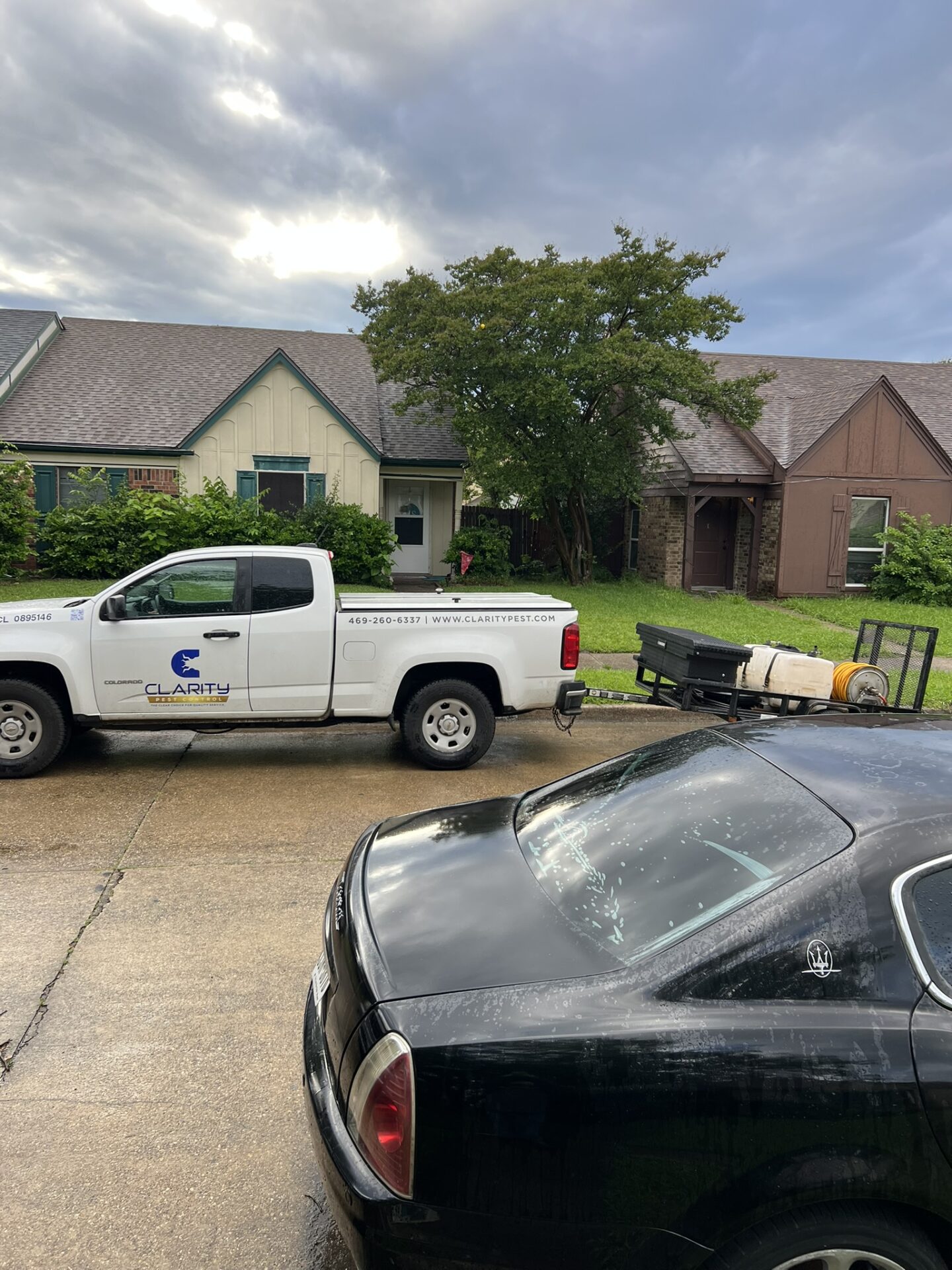 The image shows a man fogging the grassy lawn to keep the bugs and pests away